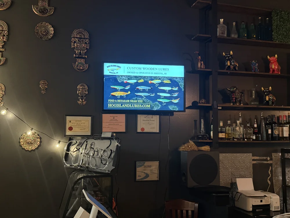 Wall screen running an ad for Hog Island Lures, a Bristol, Rhode Island lure maker